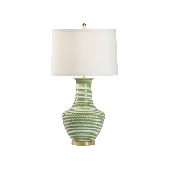 Green textured table lamp with a white shade on a white background