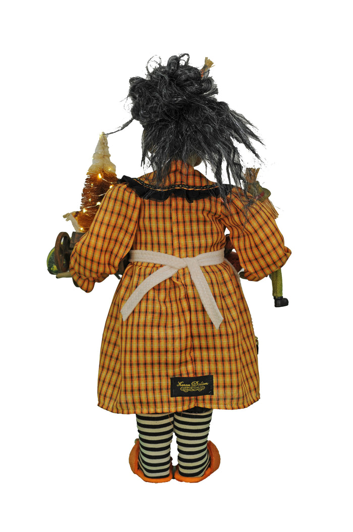 Scarecrow figurine with checkered outfit and black hair on a white background