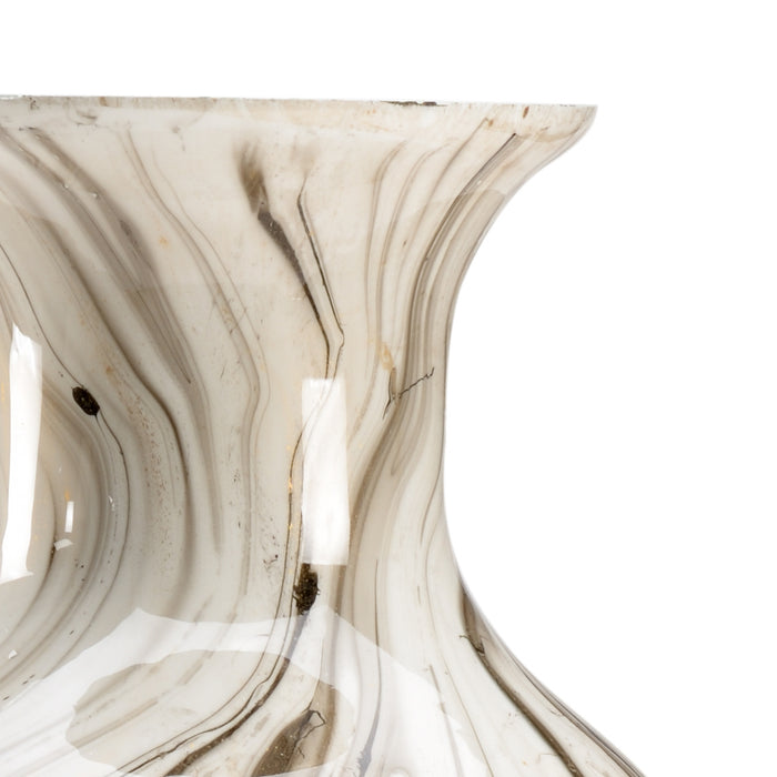 Close-up of a marble-like surface with swirling patterns on a white background