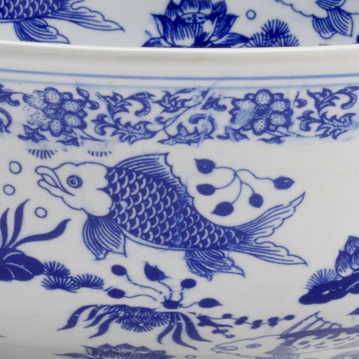 Close-up of blue floral and fish design on white ceramic surface