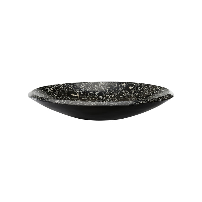 Black ceramic bowl with decorative patterns on a white background