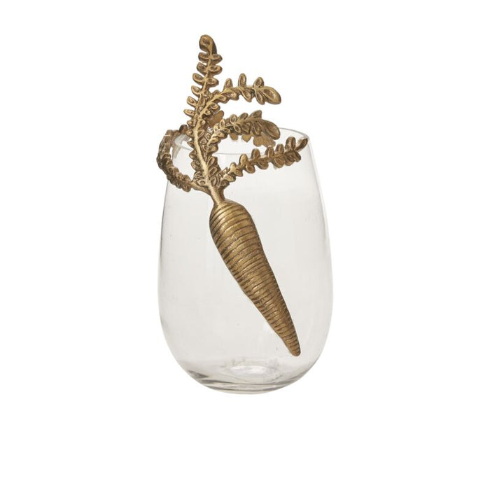Clear glass vase with a gold-tone carrot and leafy sprig as a decorative topper attached to the rim.