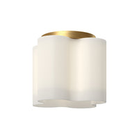 Wall-mounted light fixture with white shade and gold metal accent on a white background