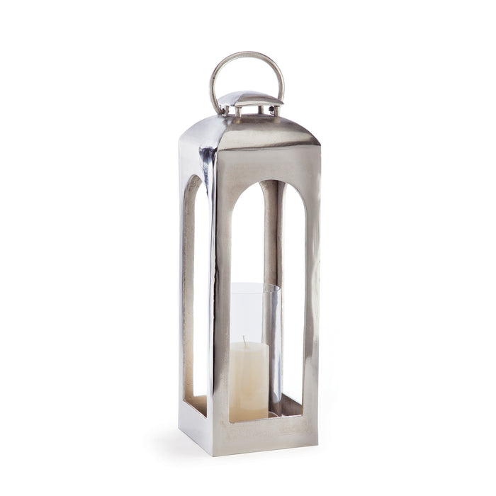 A champagne gold finish large lantern with a glass candle holder inside and a metal top.
