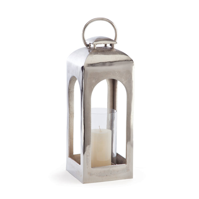 A champagne gold finish metal lantern with a glass candle holder on the bottom.