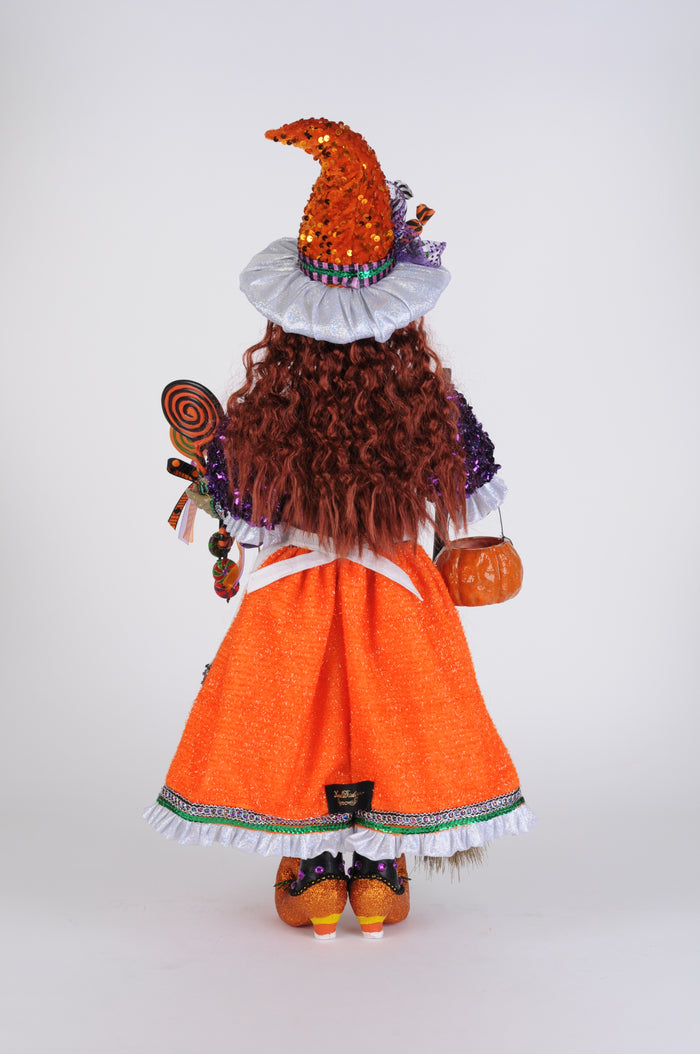 Doll with orange dress and brown hair on a white background