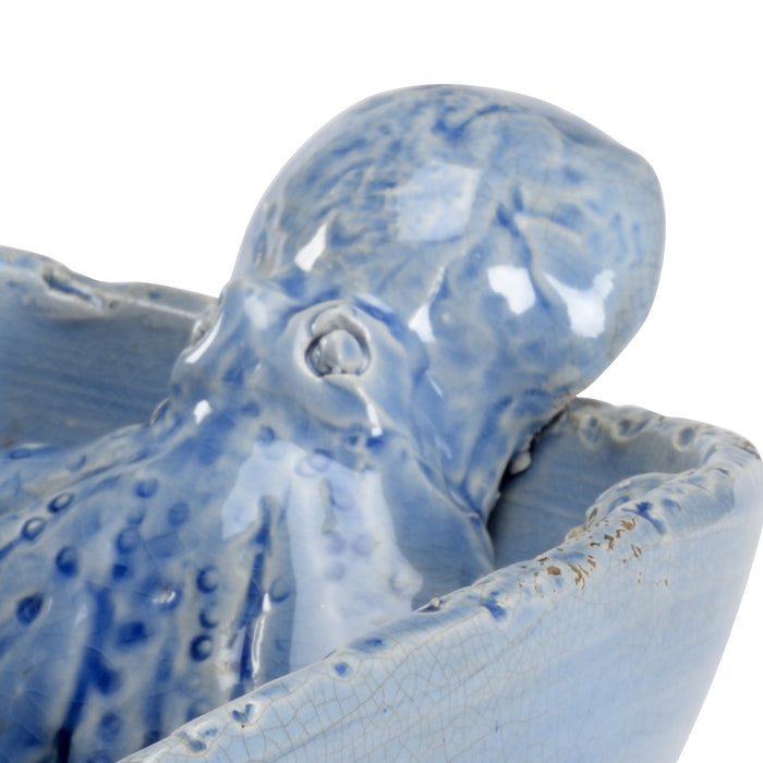 Ceramic octopus sculpture with blue and white glaze on a white background