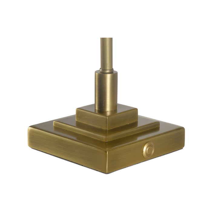 Brass-colored metal base with cylindrical top on a white background