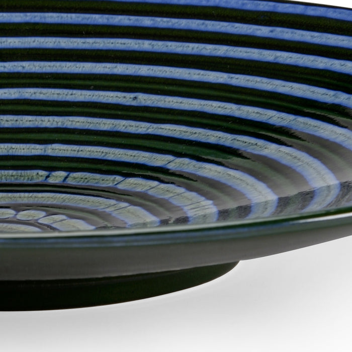 Close-up of a spool of blue and green cable on a white background