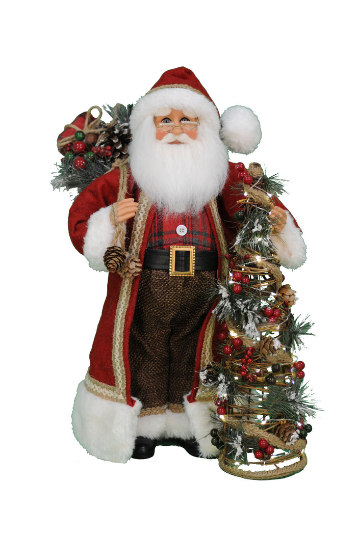 Decorative figure of Santa Claus with a small Christmas tree on a white background