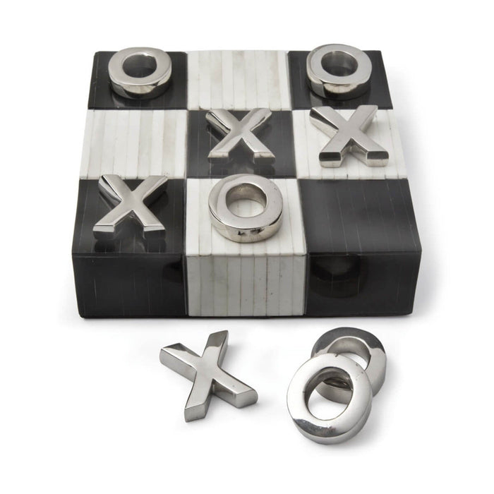 Tic-tac-toe board with metal pieces on a white background