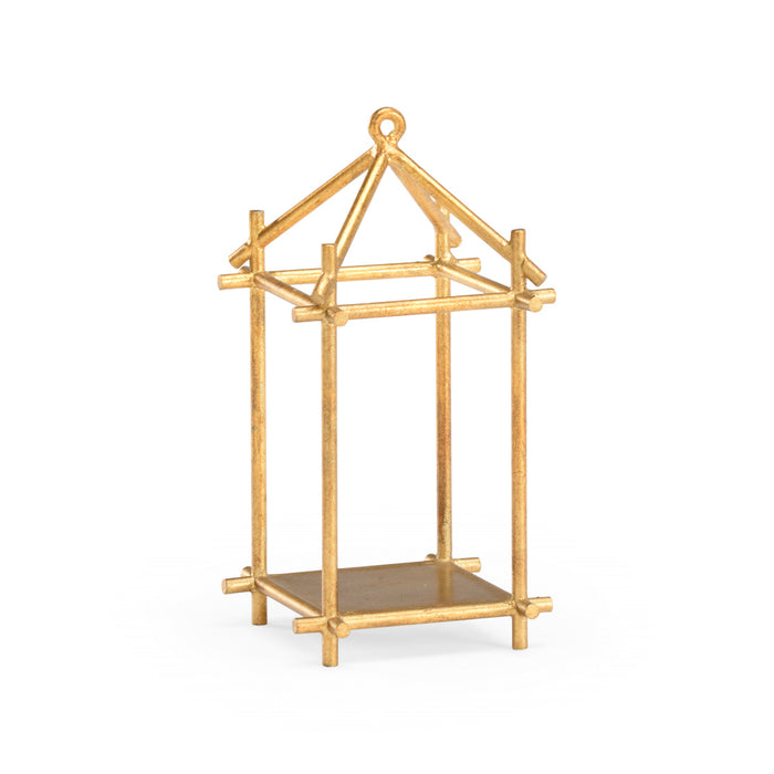 Gold decorative stand with a house-like design on a white background