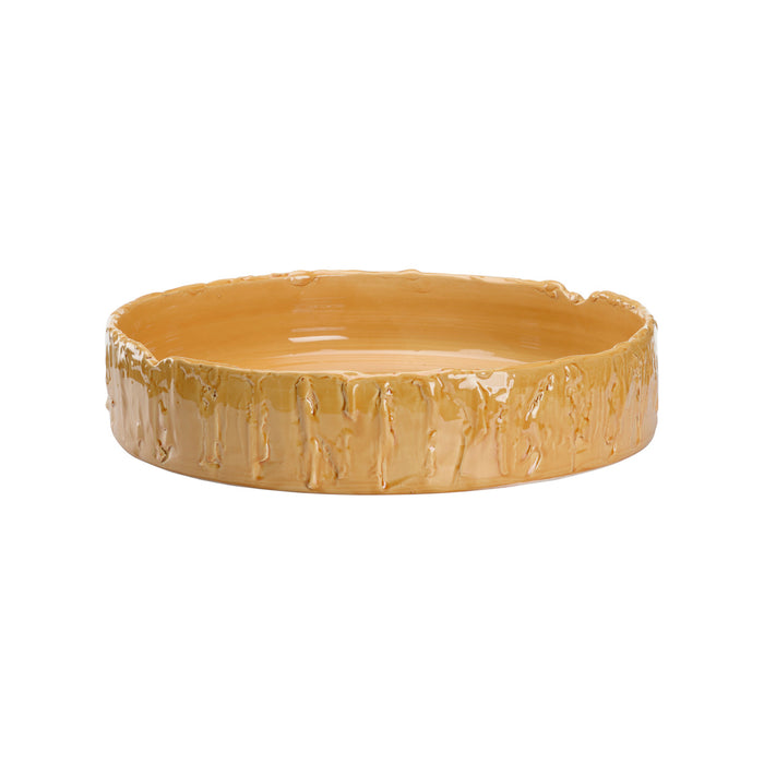 Yellow ceramic bowl with textured surface on a white background