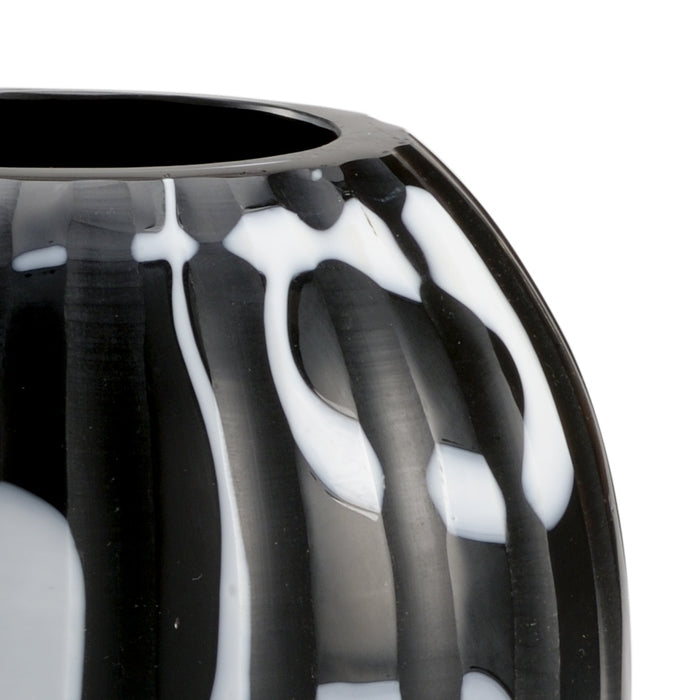 Close-up of a black and white patterned vase on a white background