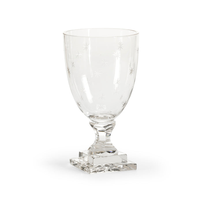 Clear glass goblet with star design on a white background