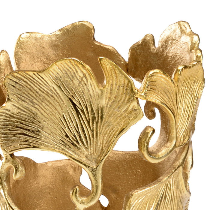 Close-up of a gold decorative item with leaf-like patterns on a white background