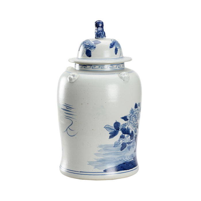 White ceramic jar with blue floral patterns on a white background