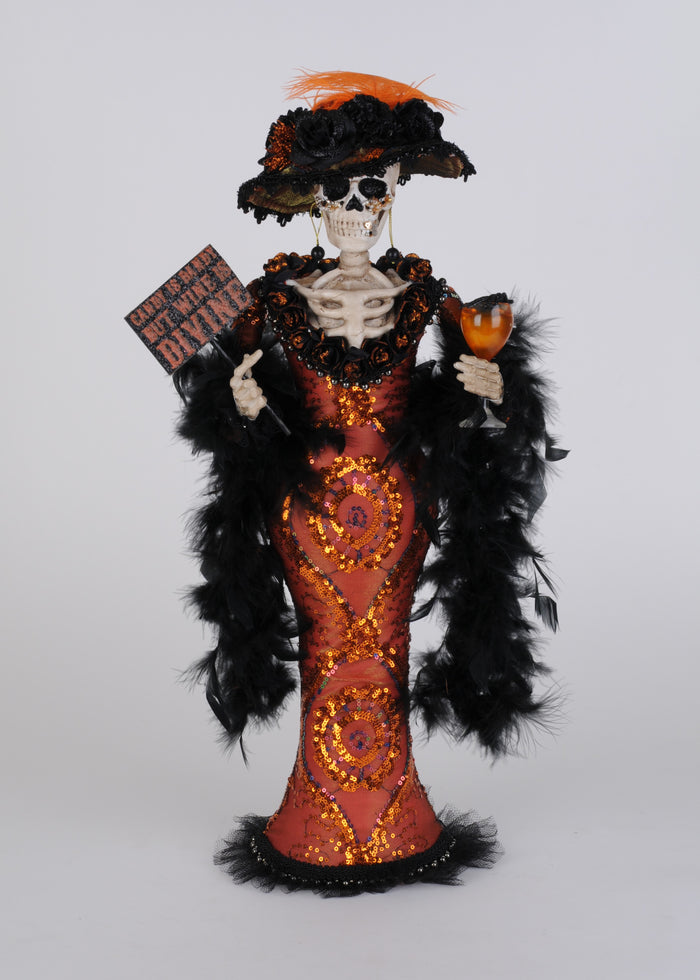 Decorative skeleton figure in a red and black outfit with a hat, holding a cocktail and sign, on a white background.