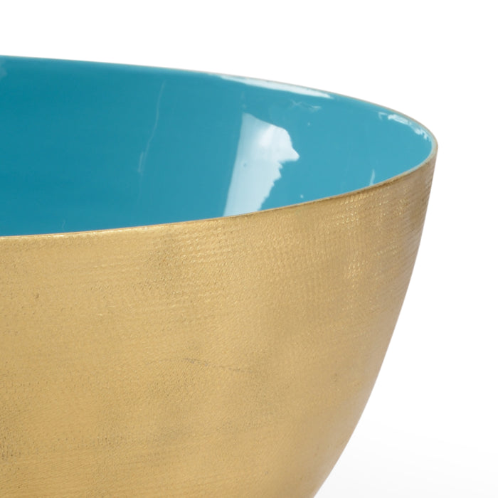 Close-up of a ceramic bowl with blue interior and gold exterior on a white background