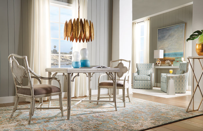 Dining room with a table and chairs, rug, and decorative elements.