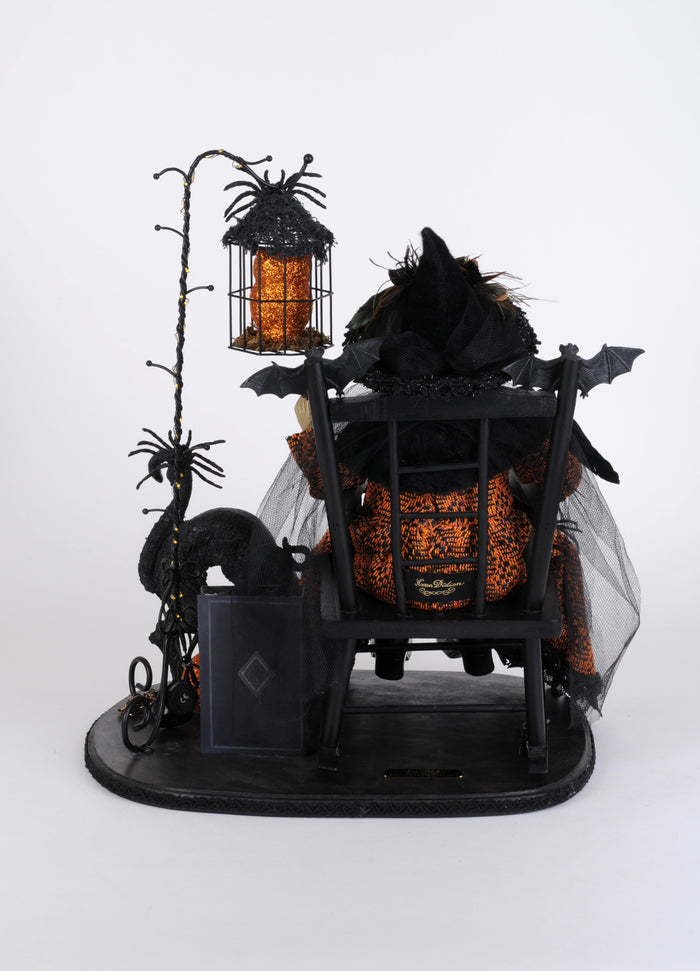 Halloween-themed decorative display with pumpkins, bats, and a lantern on a white background