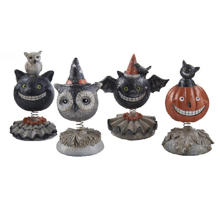 Set of Halloween-themed bobblehead figures on a white background