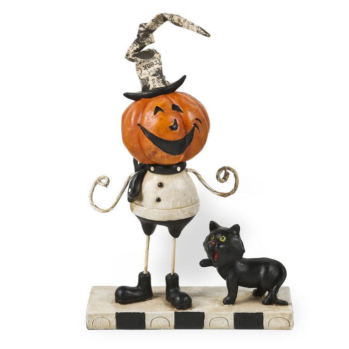 A decorative resin pumpkin man figure with a black cat. The figure features a smiling pumpkin head, white shirt, black cat, and a hat with a feather. It stands on a striped base.
