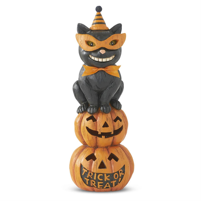 Halloween cat figurine on stacked pumpkins with 'Trick or Treat' text on a white background