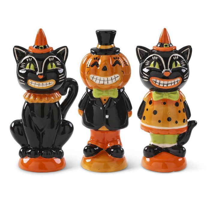 Three glossy Halloween figurines: black cats with orange hats and sashes on orange bases, plus a pumpkin-headed man in a