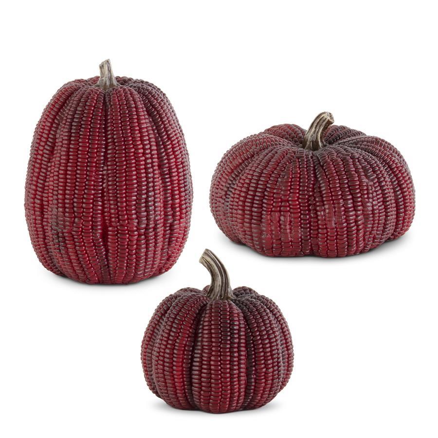 Three red beaded pumpkins on a white background