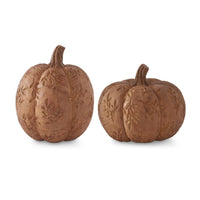 Two brown decorative pumpkins with embossed designs on a white background