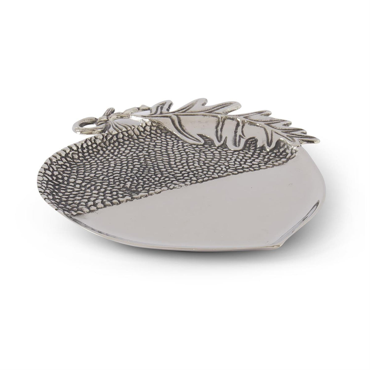 Decorative silver dish with leaf design on a white background