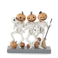 Halloween-themed figurine with skeletons and pumpkins on a white background
