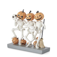 Halloween-themed figurine with skeletons and pumpkins on a white background