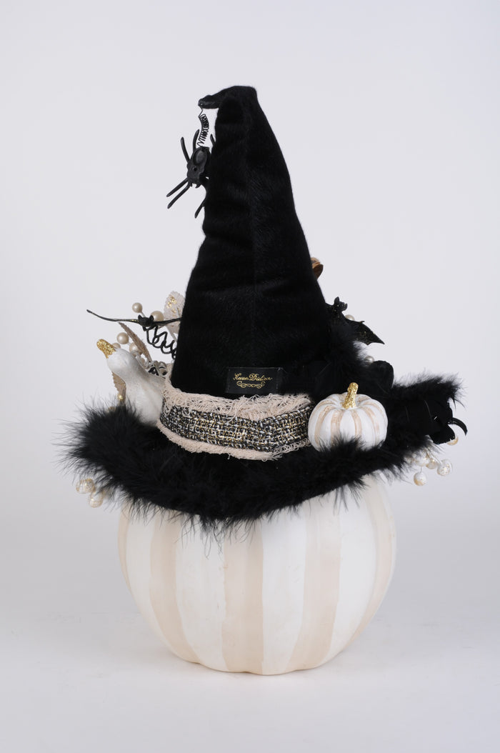Halloween-themed decoration with a black witch hat, white pumpkin, and decorative elements on a white background