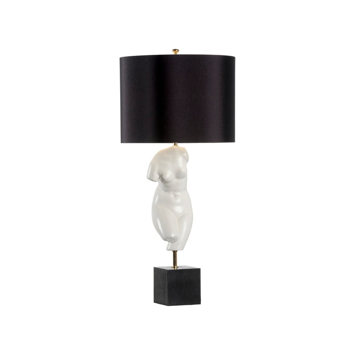 Table lamp with black shade and abstract white base on a white background