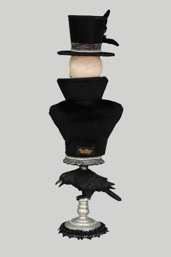 Stack of black top hats with a raven on a gray background