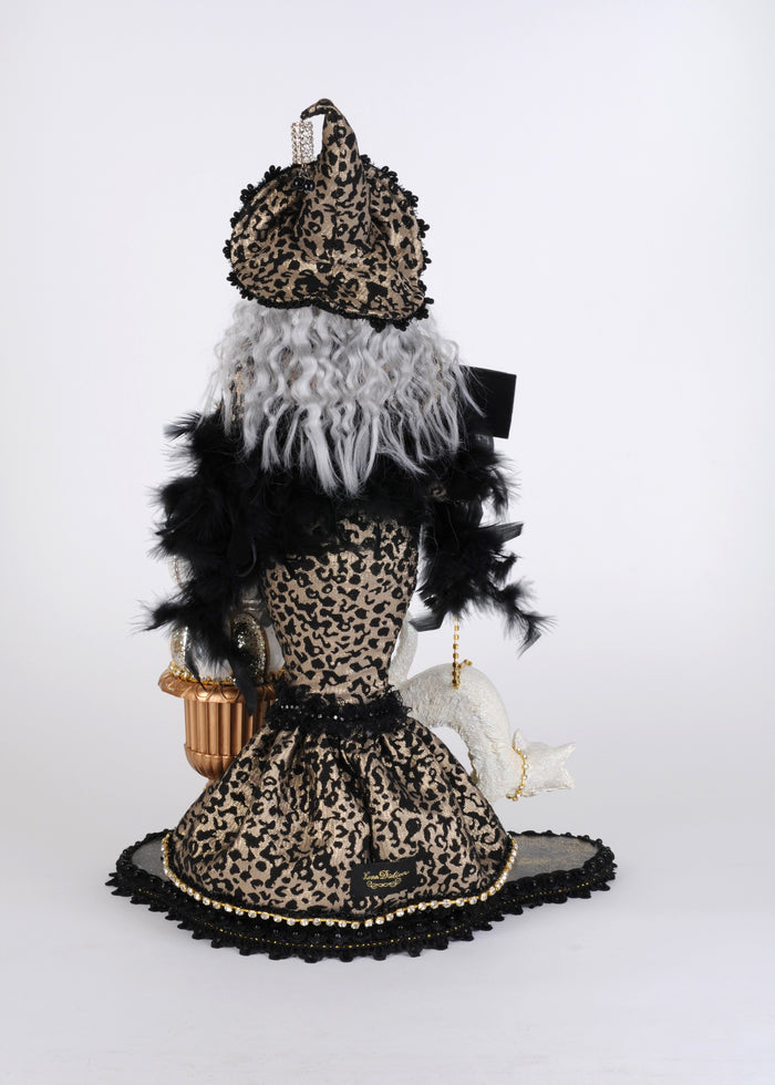 Mannequin dressed in leopard print with feathered accents on a white background