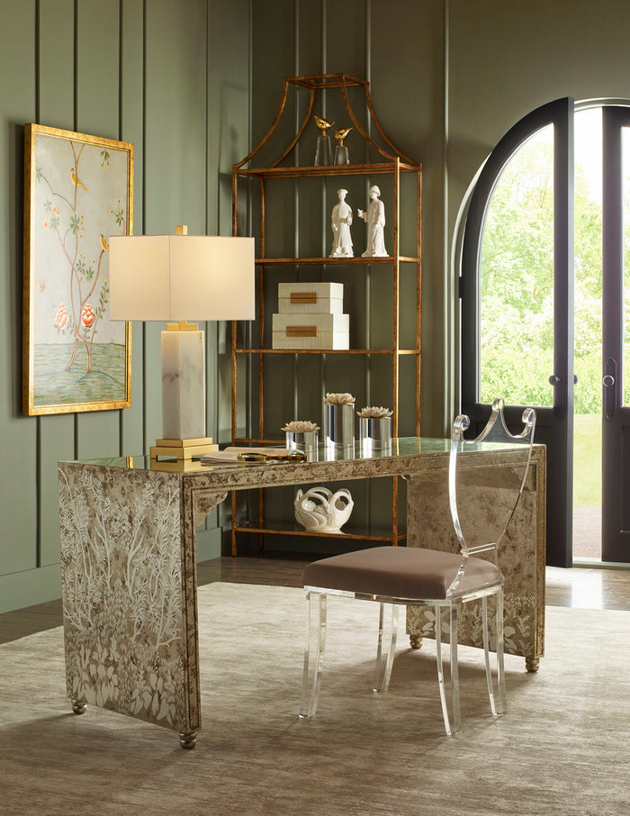 Decorative interior with a desk, chair, and bookshelf against a green wall.