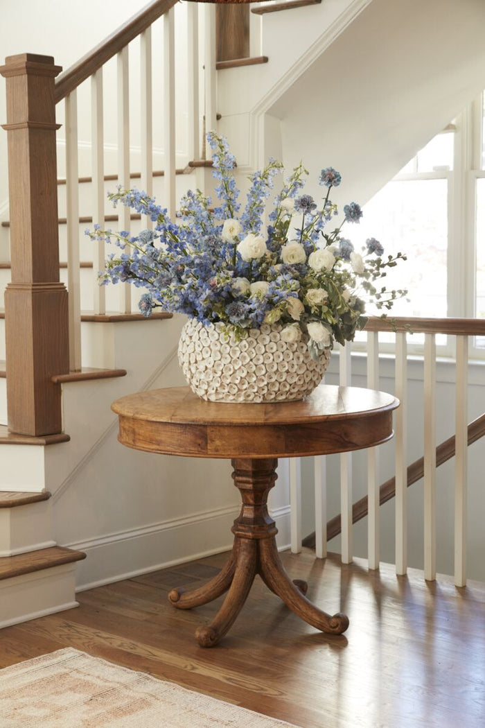 Wooden table with a floral arrangement in a home setting