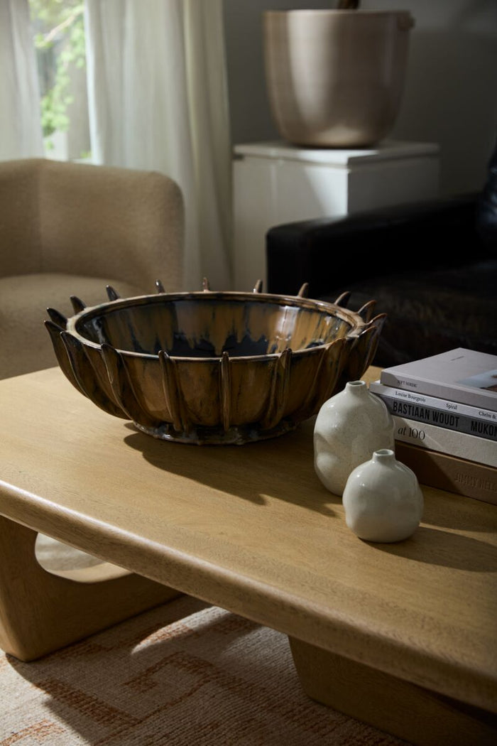 Wooden coffee table with decorative items in a living room setting
