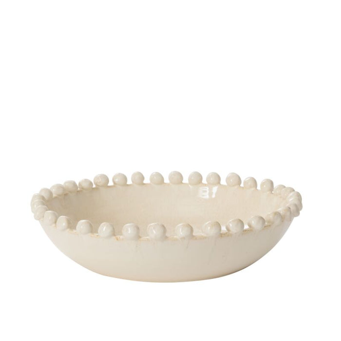 White ceramic bowl with bead-like embellishments on a white background