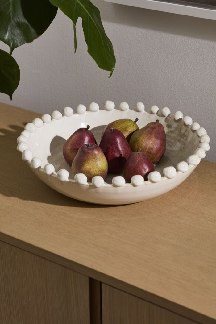 Decorative bowl with pears on a wooden surface