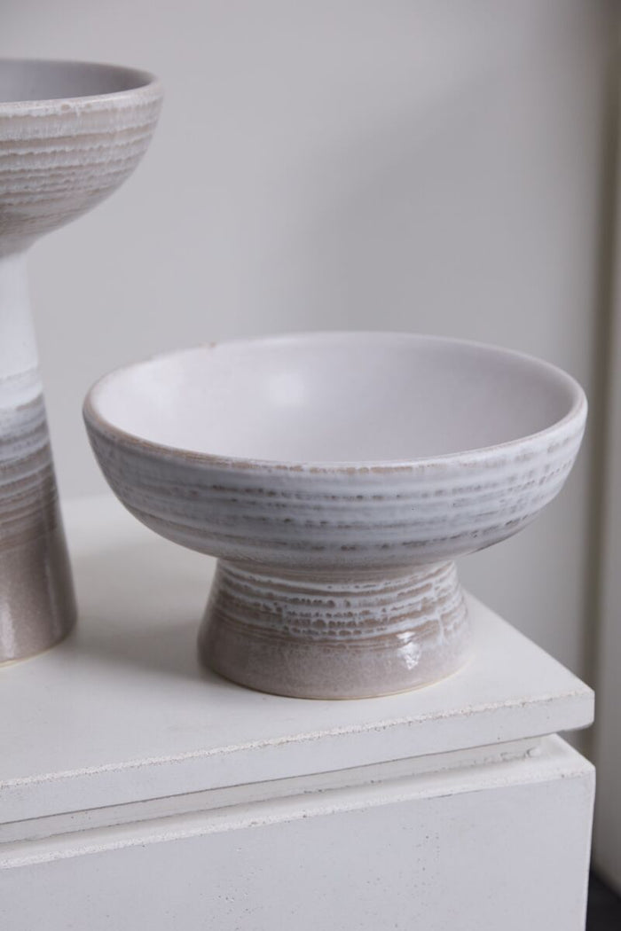 White ceramic bowl on a white surface with a neutral background