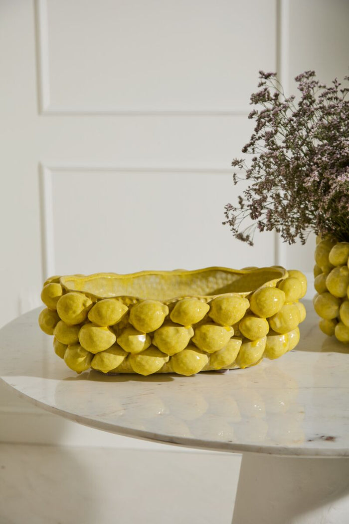Yellow woven basket on a white surface with a blurred background