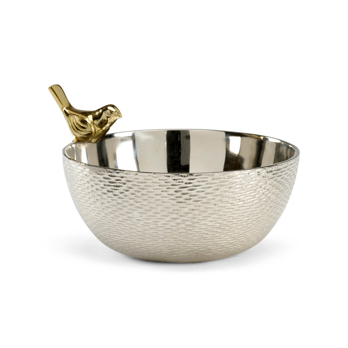 Silver bowl with textured surface and gold bird ornament on a white background