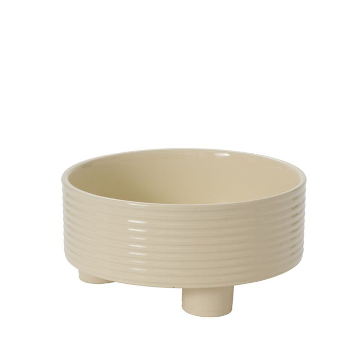 Beige ceramic planter with ribbed design on a white background