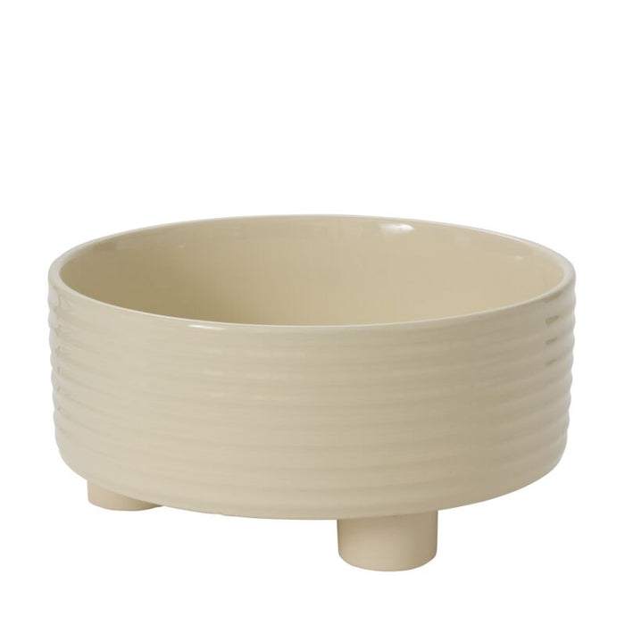 Beige ceramic planter with three legs on a white background