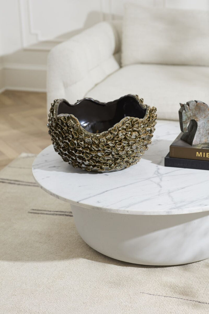 Decorative bowl on a marble coffee table with a neutral background