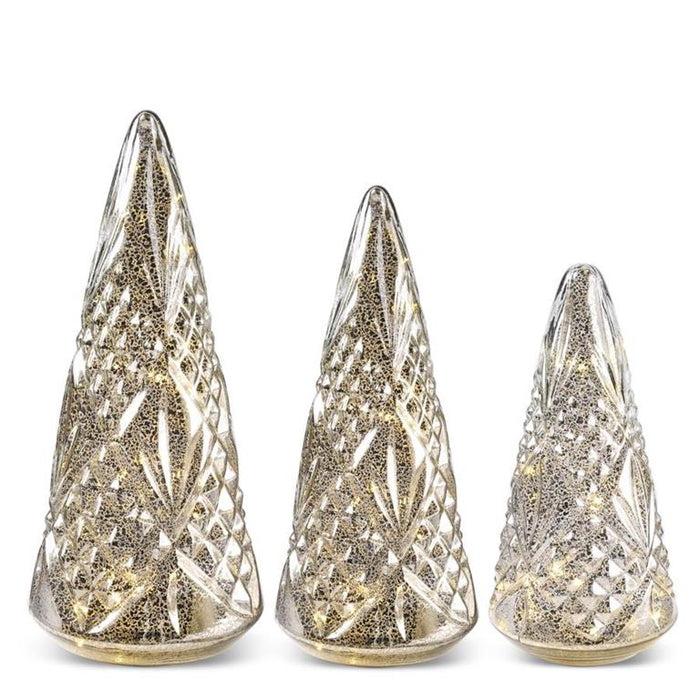 Three decorative Christmas tree cones with a metallic finish on a white background